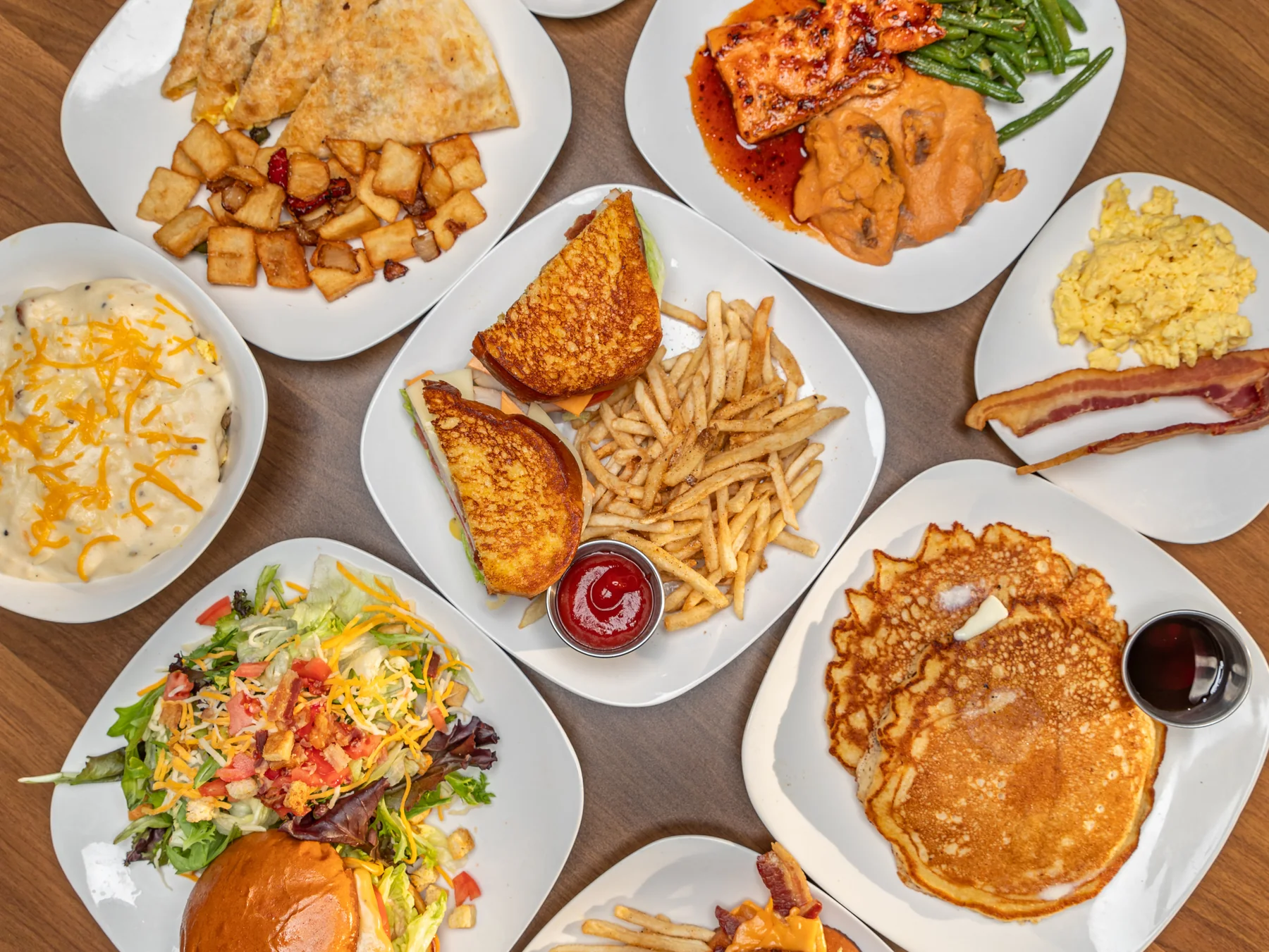 Jay’s food spread featuring breakfast, sandwiches, salmon, pancakes, salad and comfort-food favorites
